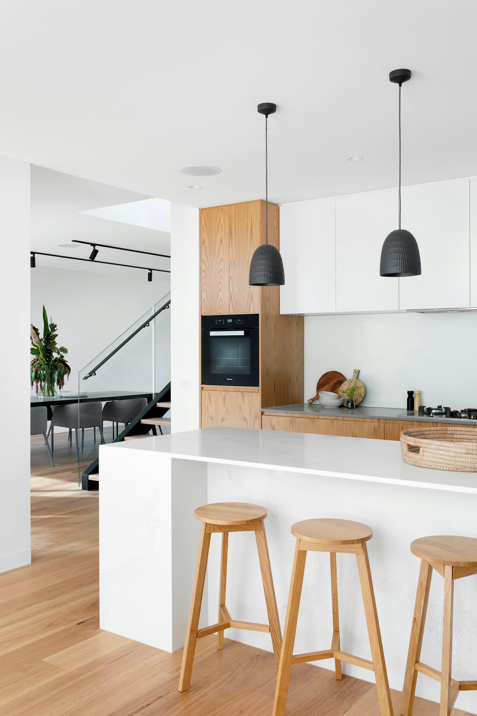 Kitchen with rift white oak cabinets and white slab doors